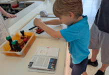 Child stamping a National Parks Passport Book
