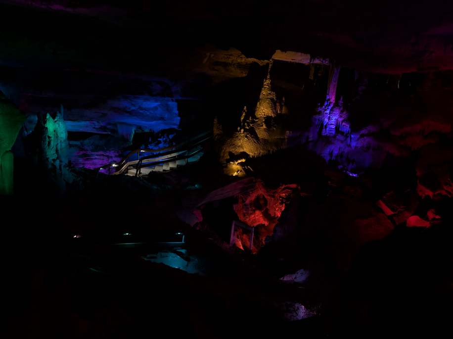 colorful lights illuminating the rock formations in the main chamber